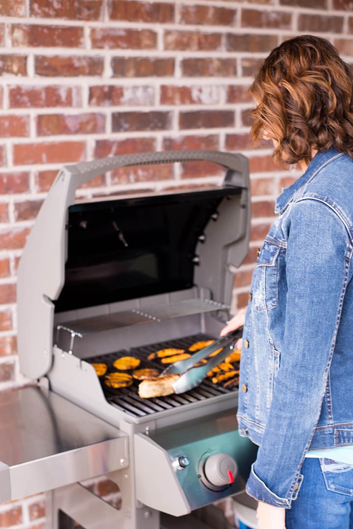 Lacey cooking chicken and veggies on the Webber grill.