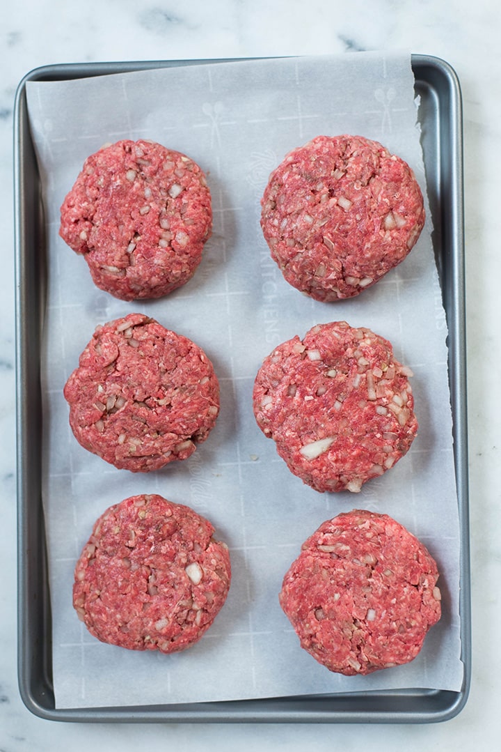The Easy Meal Prep Salisbury Steak patties on a baking tray ready to be cooked in the meal prep recipe
