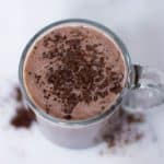 Mocha latte garnished with cocoa powder in a mug ready to be enjoyed.