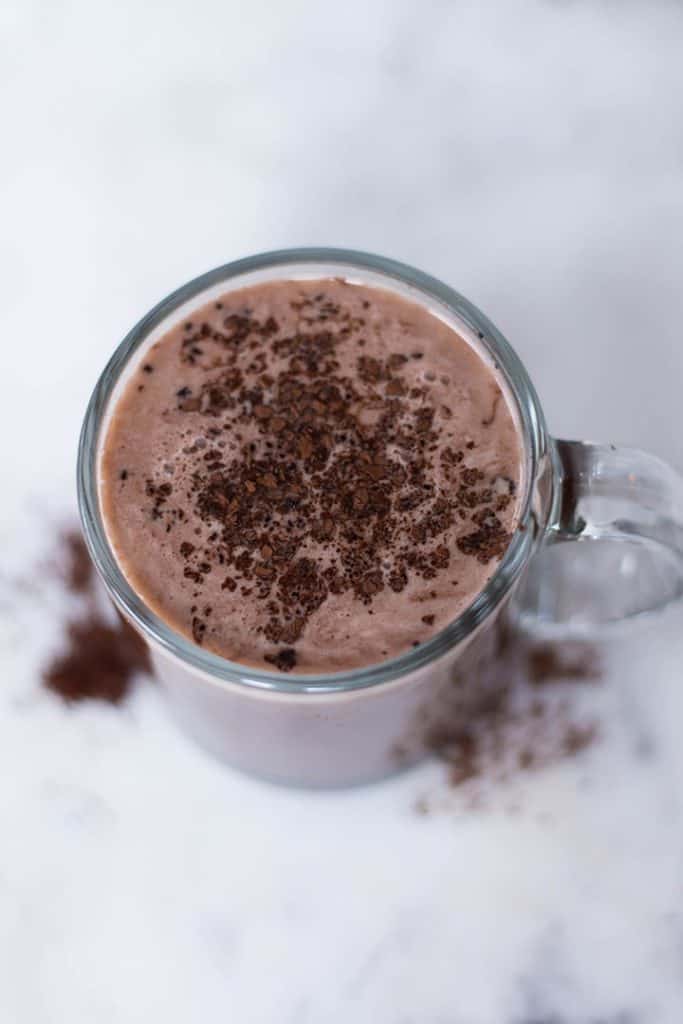 Mocha latte garnished with cocoa powder in a mug ready to be enjoyed.