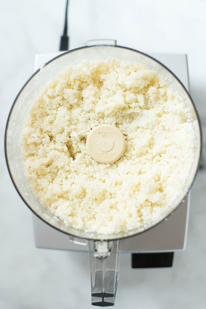 Overhead image of freshly made riced cauliflower in the food processor, ready to be prepared.