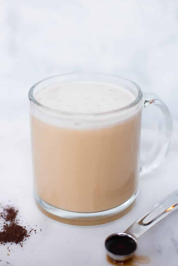Side view of a glass mug filled with healthy vanilla latte.