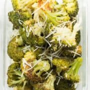 Parmesan garlic roasted broccoli in a meal prep container. The broccoli meal prep was garnished with parmesan.