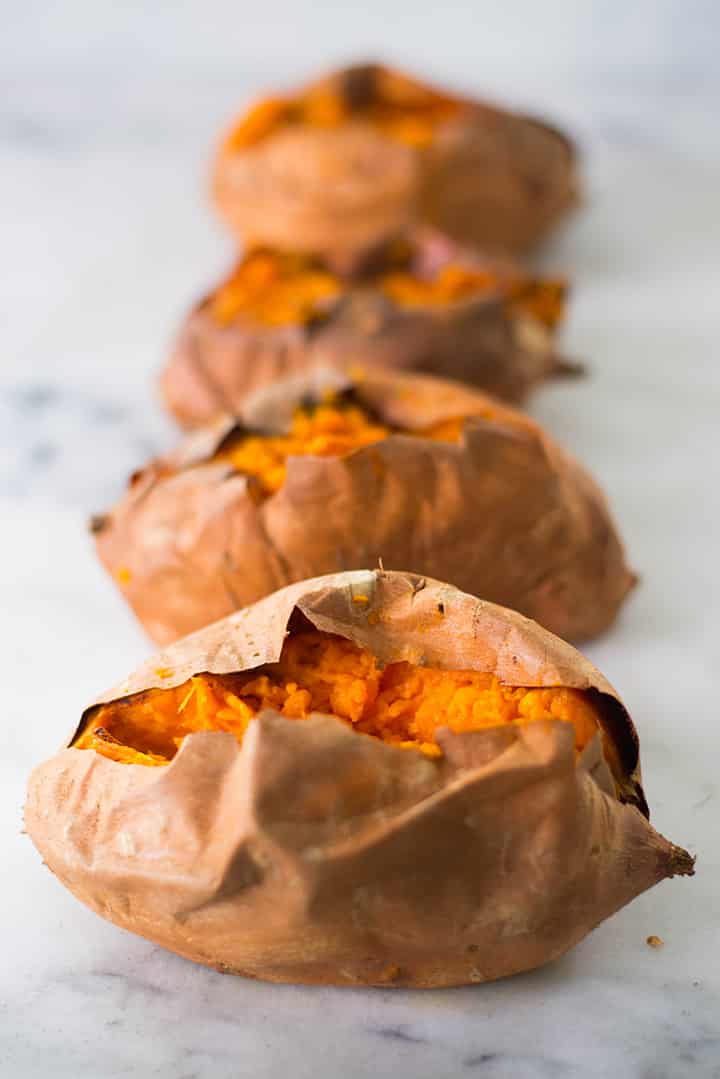 Baked sweet potatoes that have been cut down the center to add stuffing.