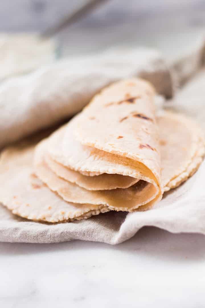 Close up of cassava flour tortillas on a kitchen towel.