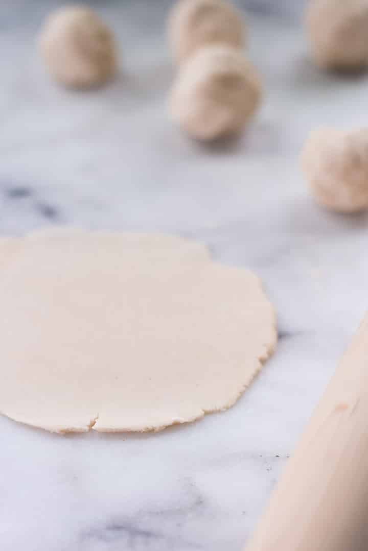 Making cassava flour tortilla with rolling pin.