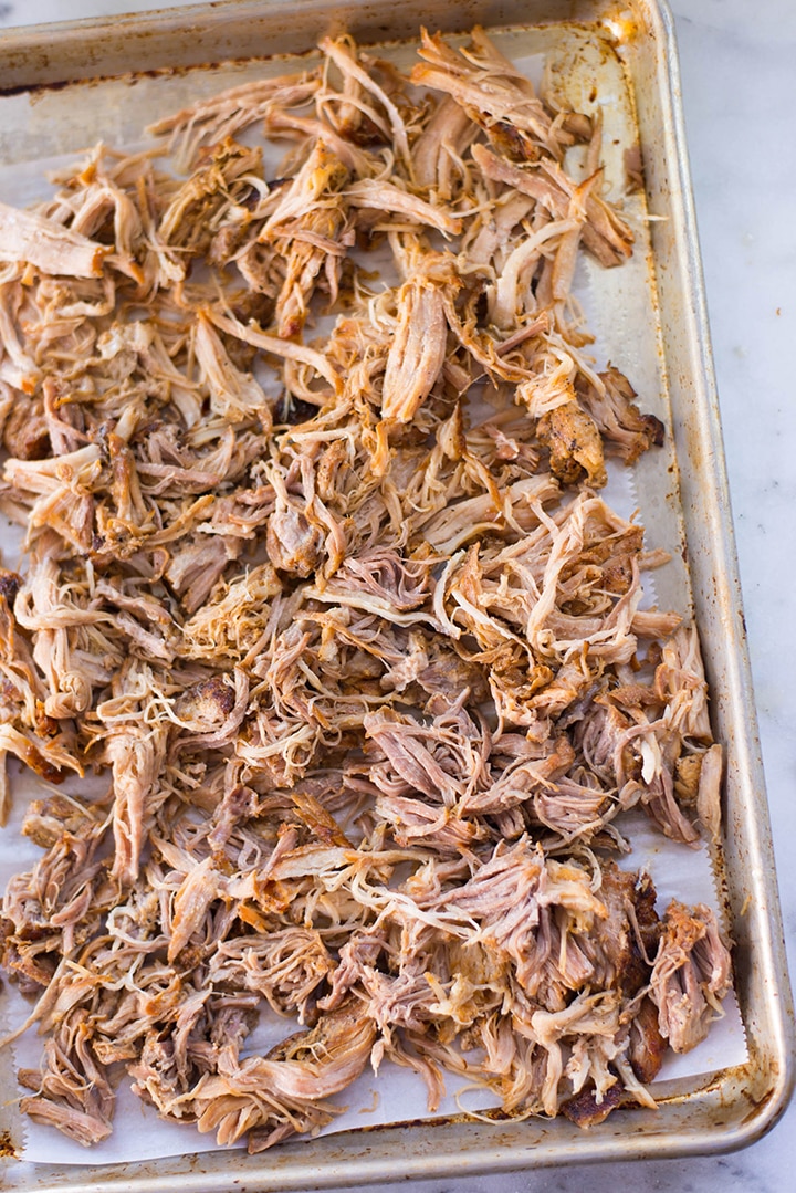 Top view of pulled pork on a baking tray.