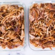 Top view of BBQ pulled pork in meal prep containers.