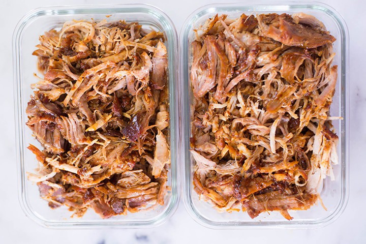Top view of BBQ pulled pork in meal prep containers.