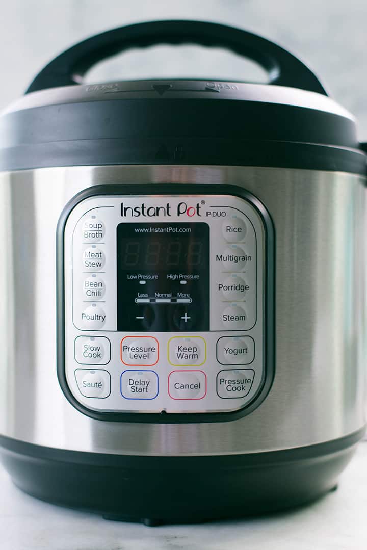 Side view of the Instant Pot that will be used for making recipes like pulled pork, with a close up view of the function buttons.