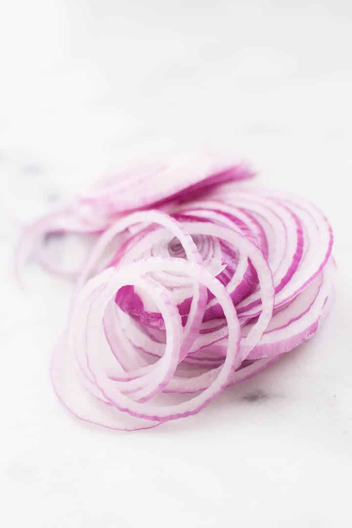 Top view of red onion thinly sliced.