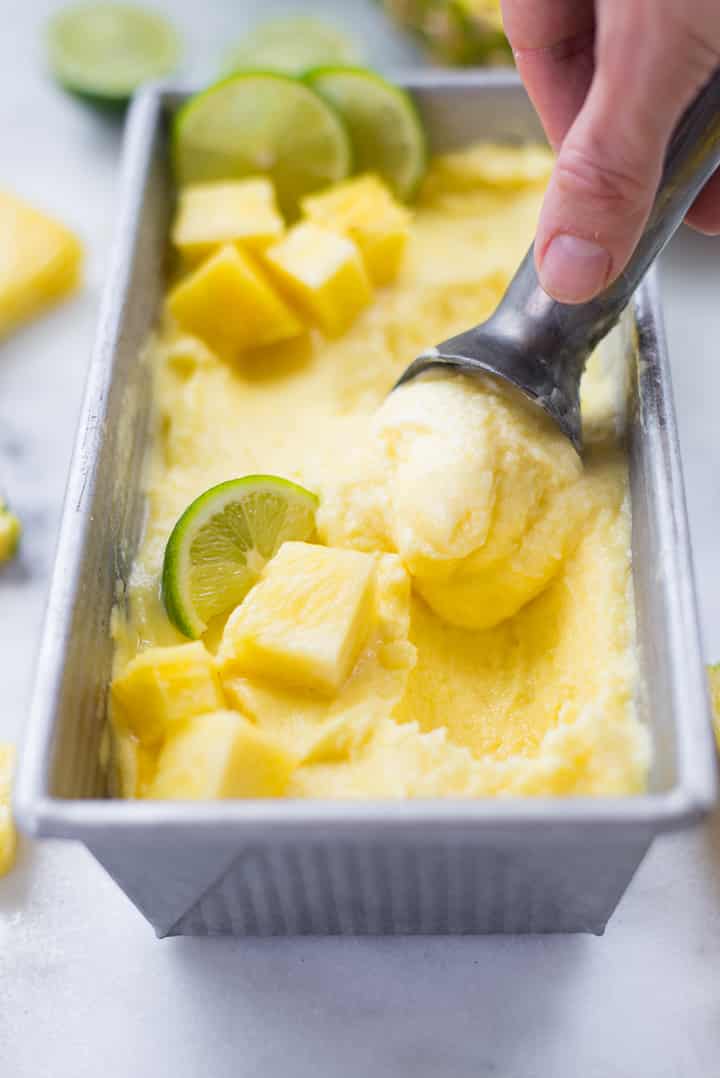 Pineapple sorbet garnished with pineapple cubes and lime slices.