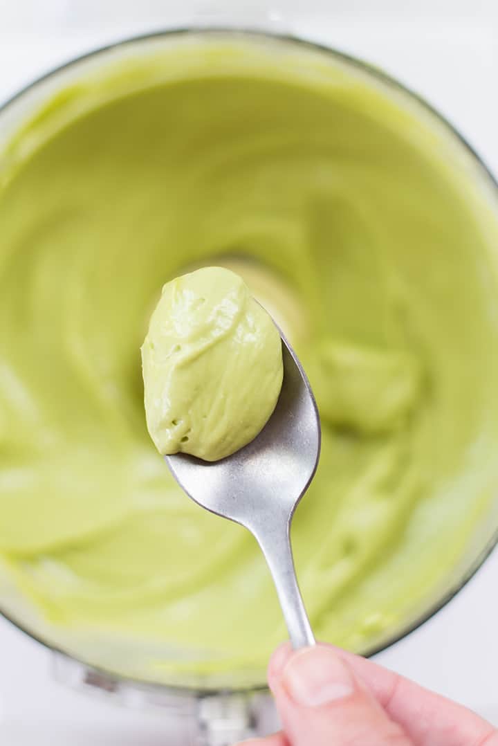 Spoonful of avocado ice cream from the food processor, ready to be transferred to the freezer to fully harden.