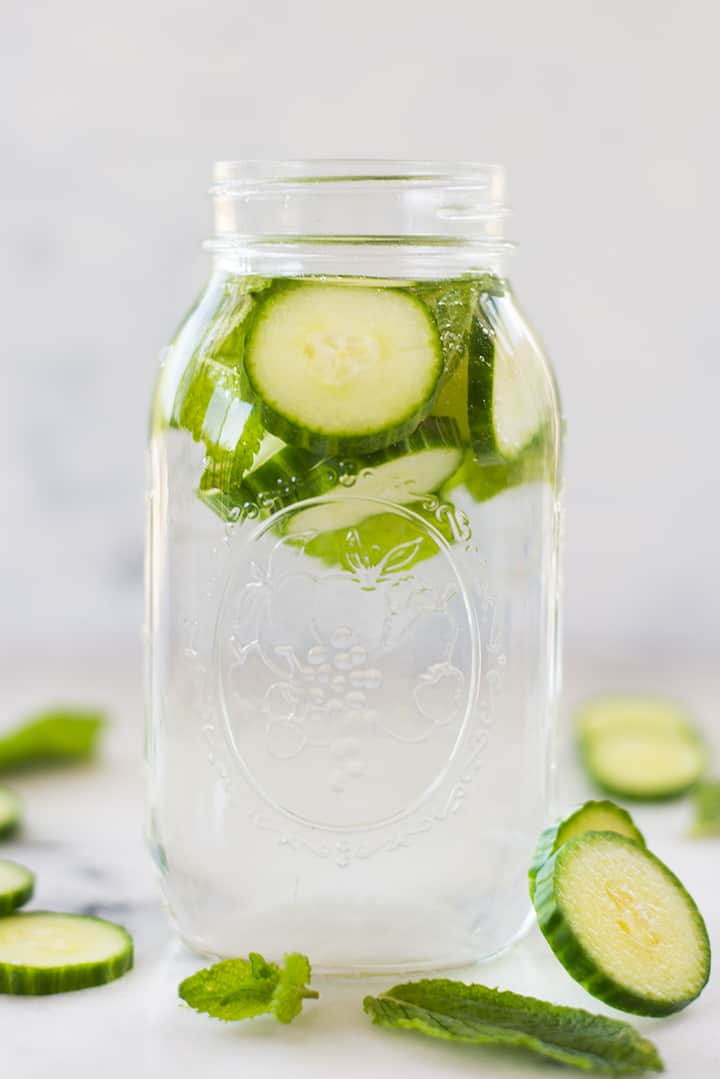 1 quart mason jar filled with cucumber, mint, and water for infused water.