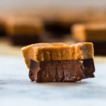 Side view of a single piece of Easy Chocolate Peanut Butter Fudge which has been bitten to show the texture.