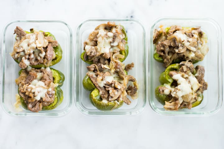 Overhead view of three Keto Philly Cheesesteak Stuffed Peppers Meal Preps in glass containers ready to store in the fridge as pre-prepared meals