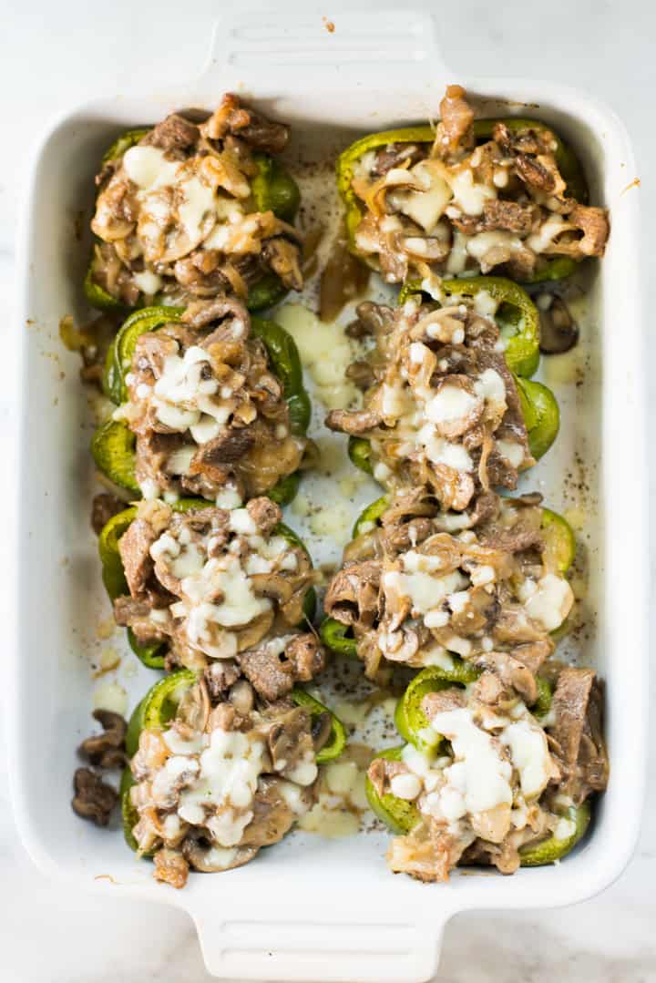 Overhead view of Keto Philly Cheesesteak Stuffed Peppers served in a white glass dish, and ready to eat