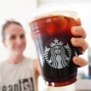 lacey holding up an iced caffe americano to demonstrate a healthy starbucks drink