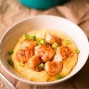 top down view shrimp and grits plated in a bowl