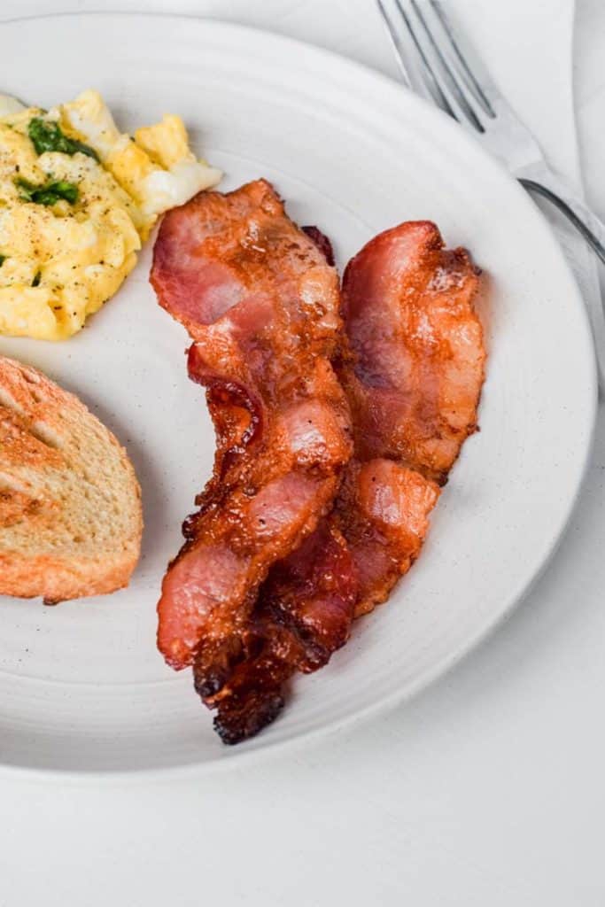 Are you a lover of tasty and crisp bacon? Learn how to cook bacon in the oven and you’ll never use the stove top again!