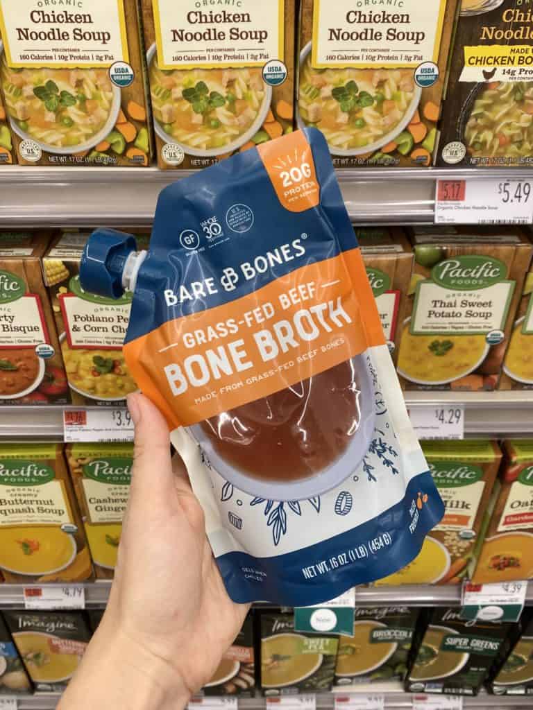 bare bones grass fed  bone broth being held in a grocery store