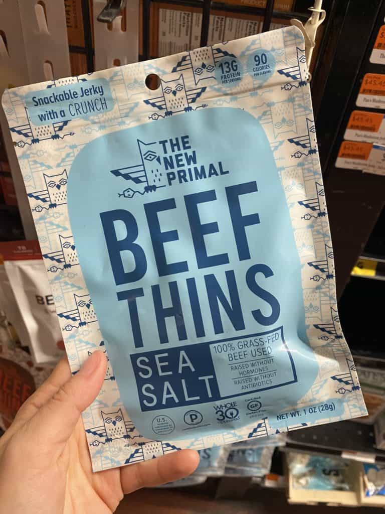 The New Primal Beef Thins package being held in a store