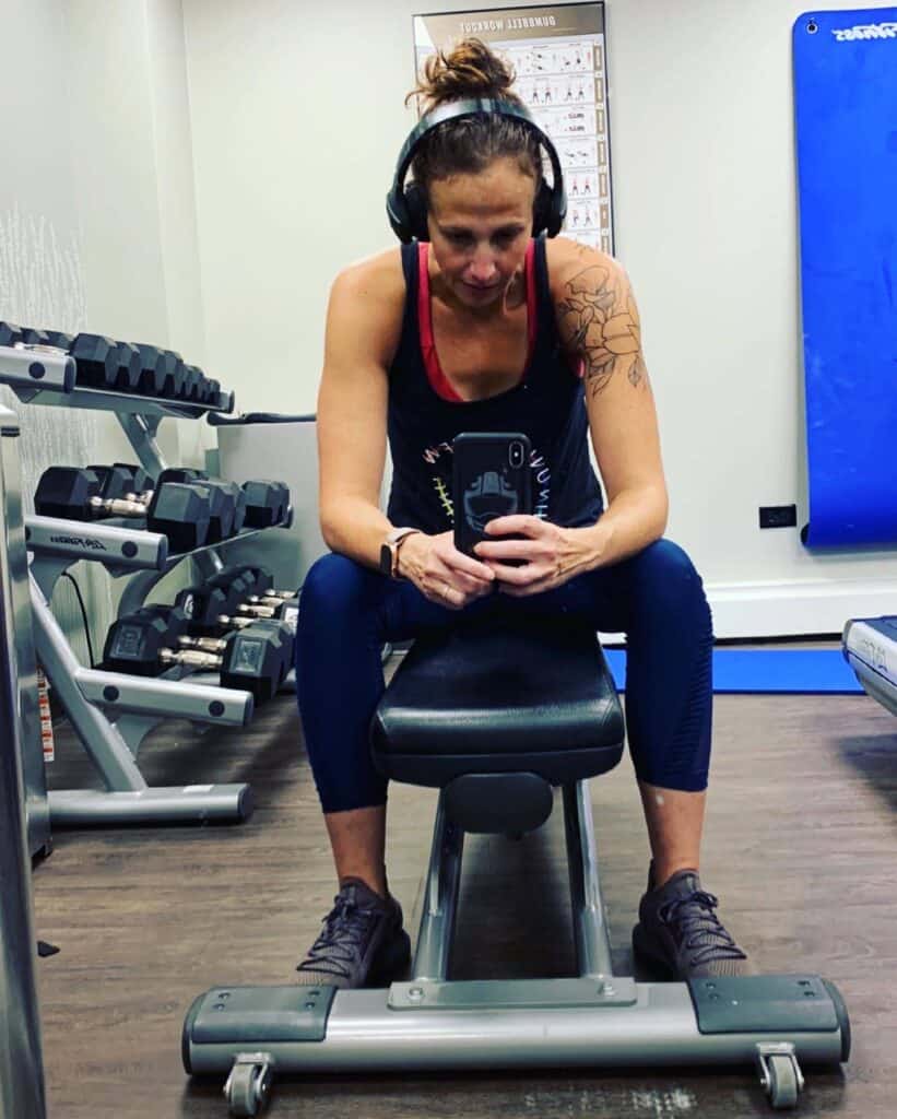 Lacey Baier working out in a gym while traveling