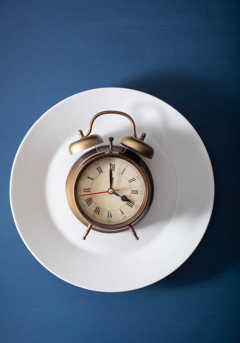 a clock on a plate symbolizing fasting time windows