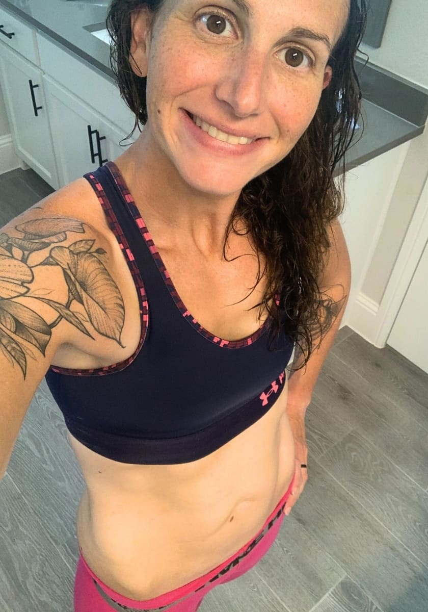 Lacey Baier weight loss coach selfie smiling and showing her stomach