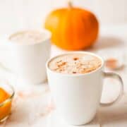 pumpkin latte with pumpkins in the background