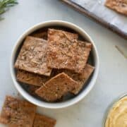 Top down view of Whole Wheat Olive Oil And Herb Crackers in a bowl.